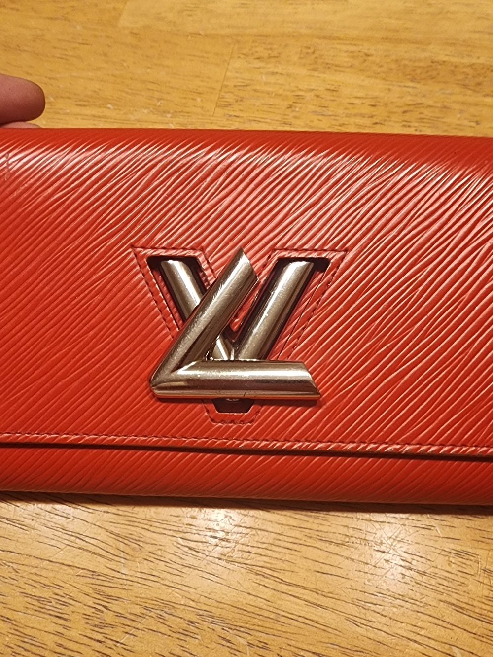 pre-owned Louis Vuitton red Epi leather Twist Wallet a silver-tone turn-lock